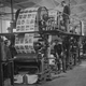 circa 1930: A group of men operating a printing press.